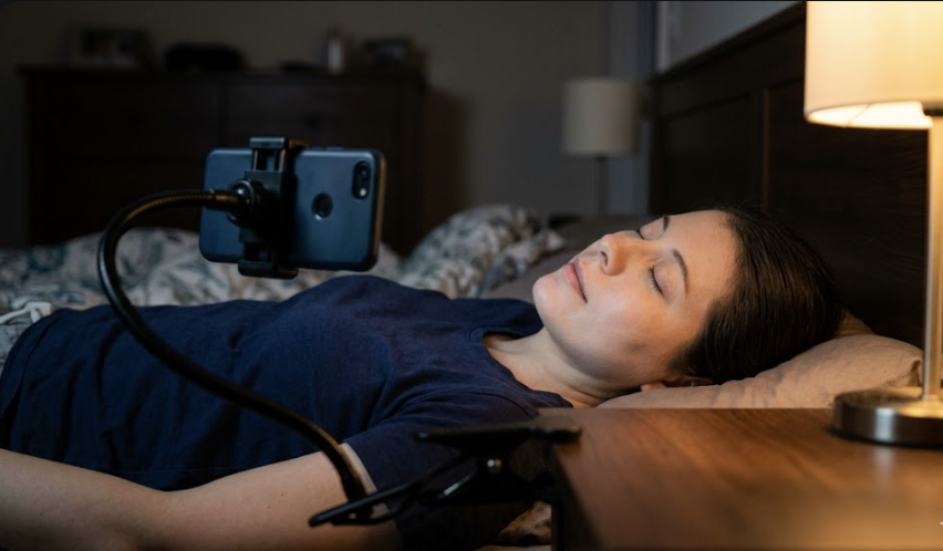 Patient recording eye movement with smartphone in dark room — BPPV nystagmus detection